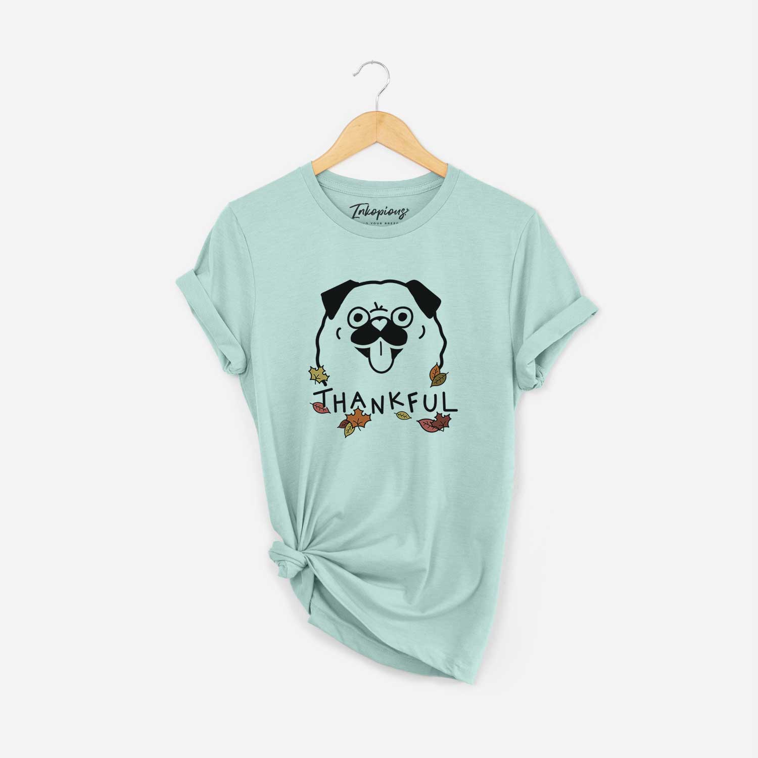 Minimalist line drawing of a Pug with 'Thankful' lettering on a Heather Sage Unisex crewneck