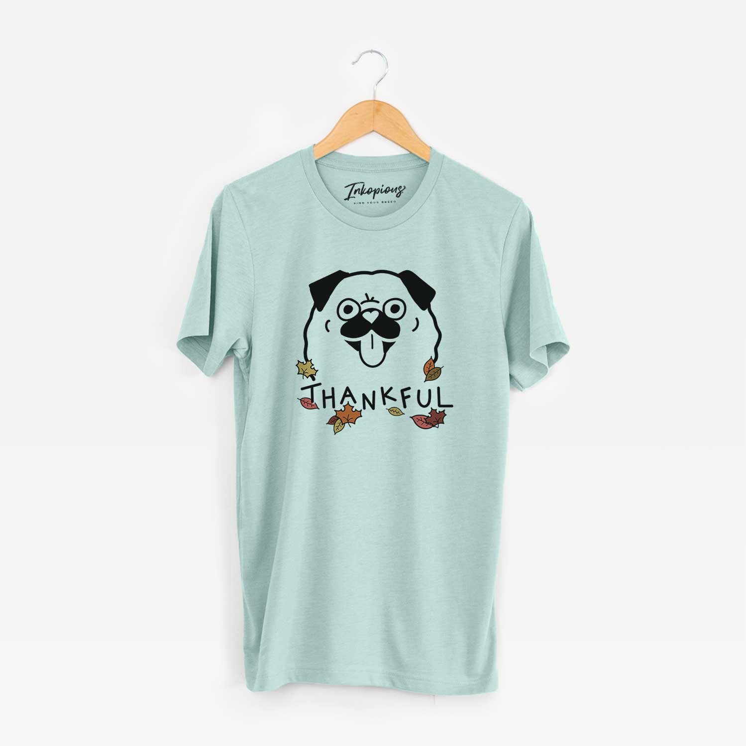 Minimalist line drawing of a Pug with 'Thankful' lettering on a Heather Sage Unisex crewneck