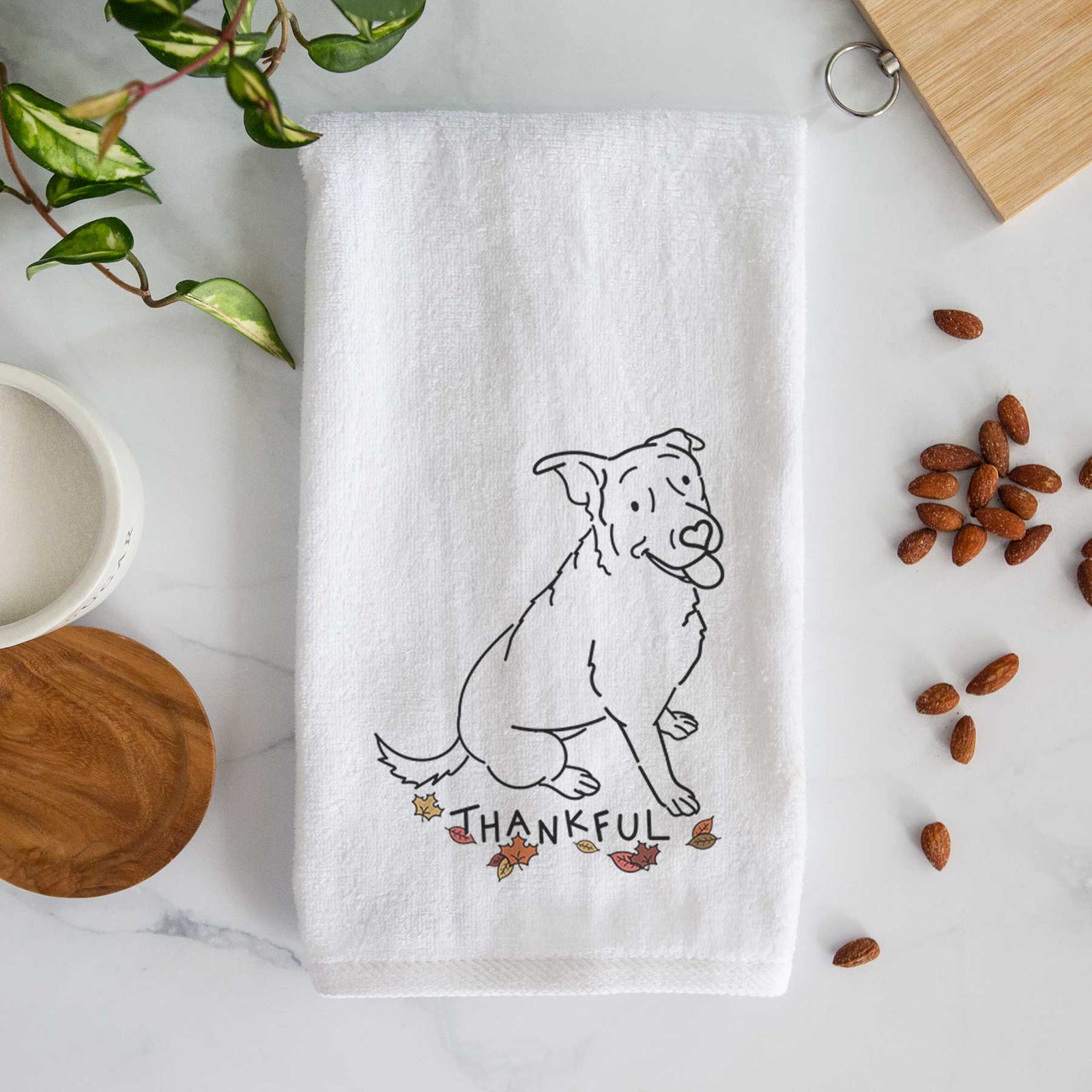 Minimalist line drawing of Rocky the Rottweiler Mix with 'Thankful' lettering on a decorative hand towel