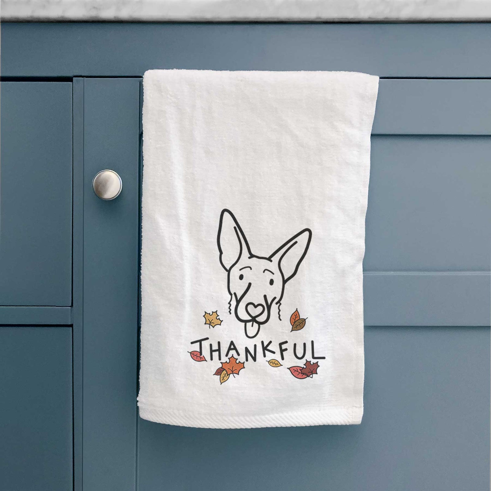 Minimalist line drawing of Rosie the Shepherd Mix with 'Thankful' lettering on a decorative hand towel