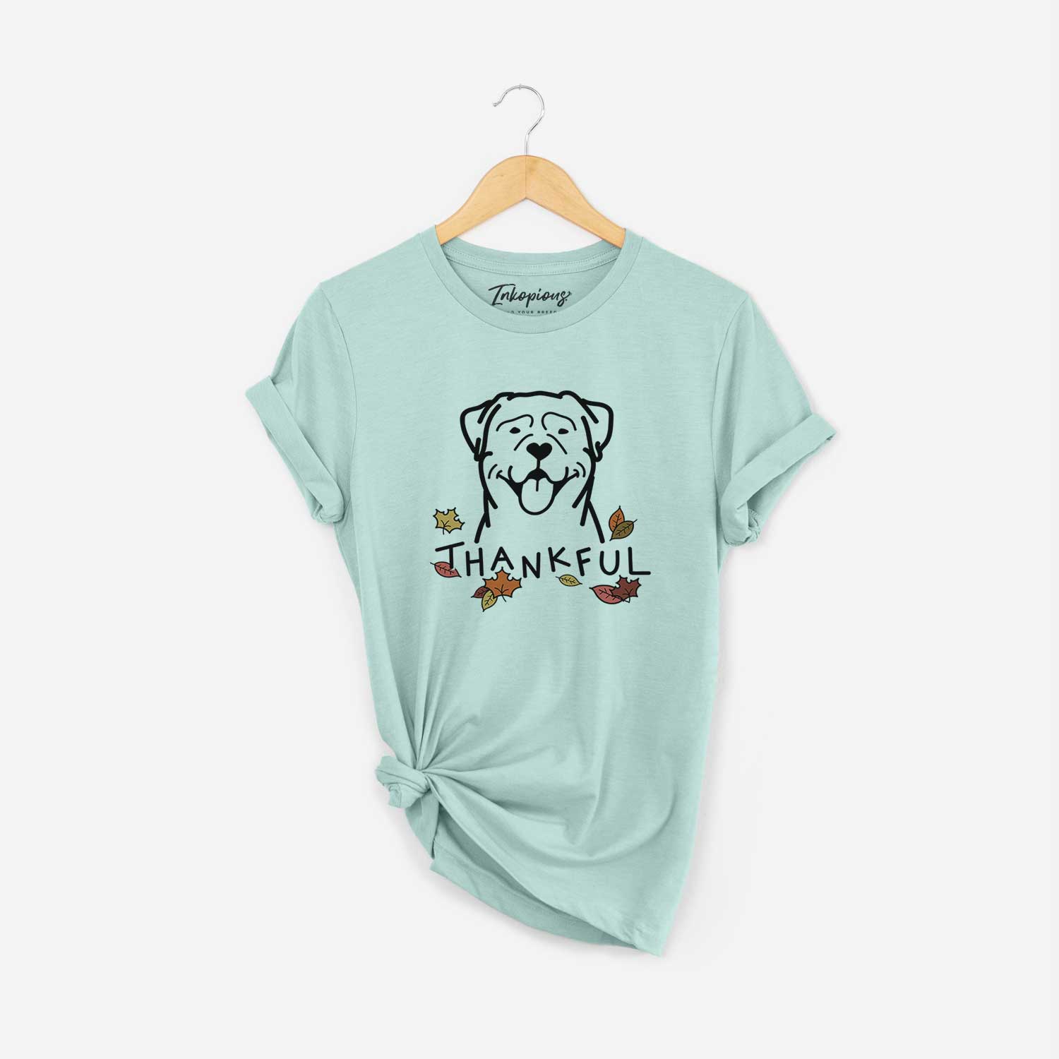 Minimalist line drawing of a Rottweiler with 'Thankful' lettering on a Heather Sage Unisex crewneck