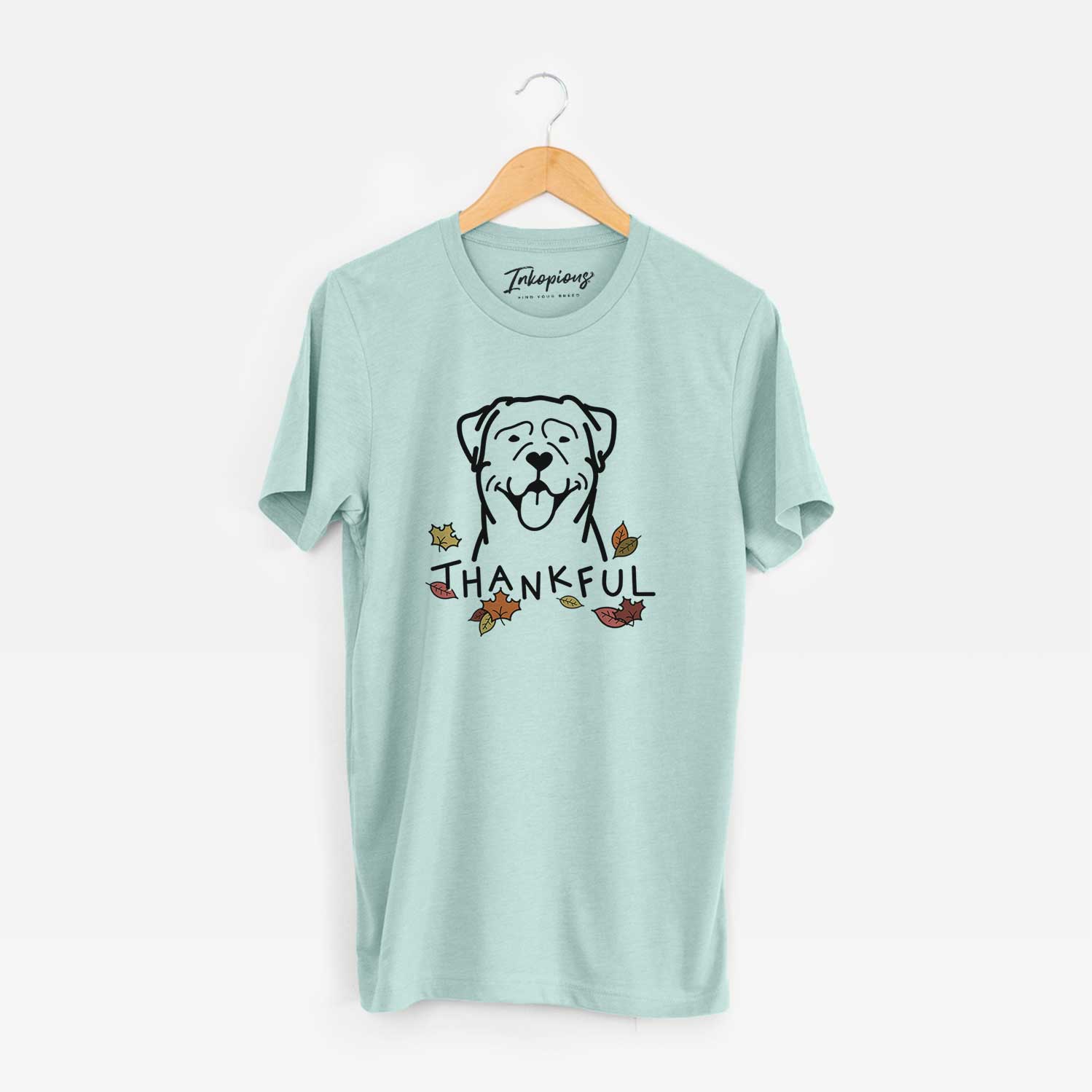 Minimalist line drawing of a Rottweiler with 'Thankful' lettering on a Heather Sage Unisex crewneck