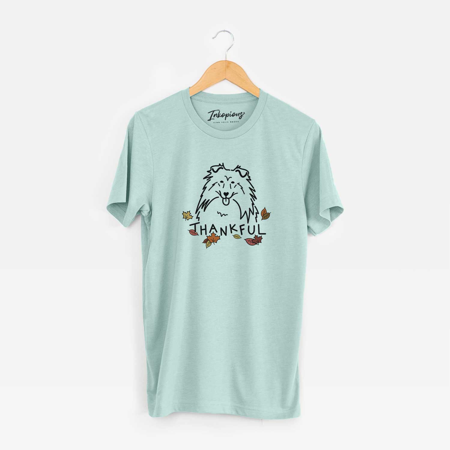 Minimalist line drawing of a Rough Collie with 'Thankful' lettering on a Heather Sage Unisex crewneck