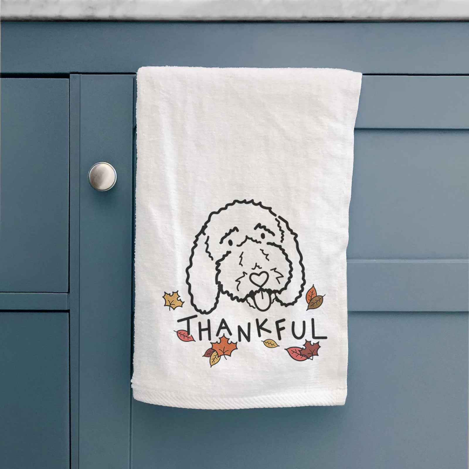 Minimalist line drawing of Ruby the Bernedoodle with 'Thankful' lettering on a decorative hand towel