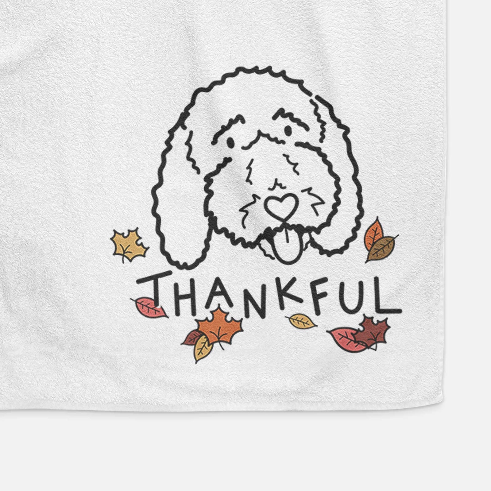 Minimalist line drawing of Ruby the Bernedoodle with 'Thankful' lettering on a decorative hand towel