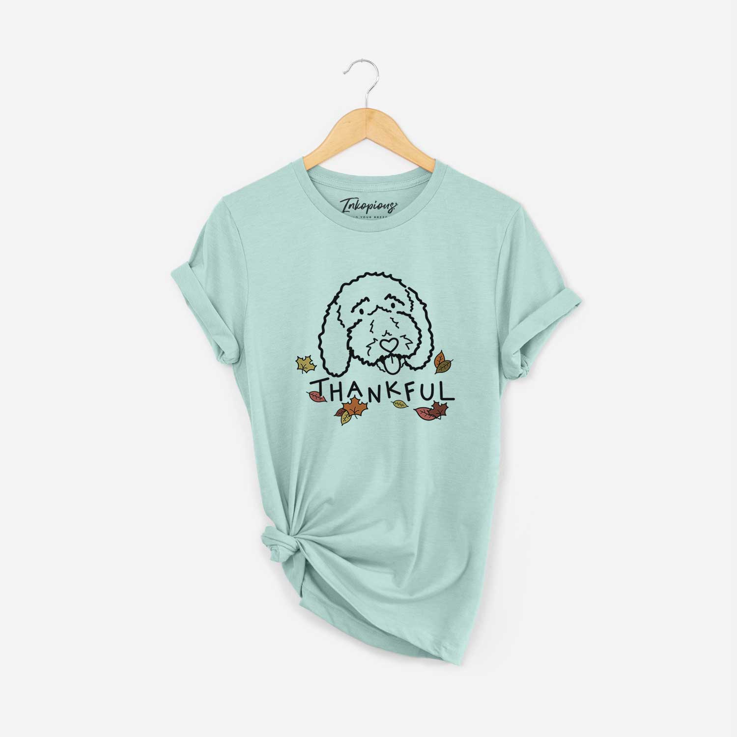 Minimalist line drawing of Ruby the Bernedoodle with 'Thankful' lettering on a Heather Sage Unisex crewneck