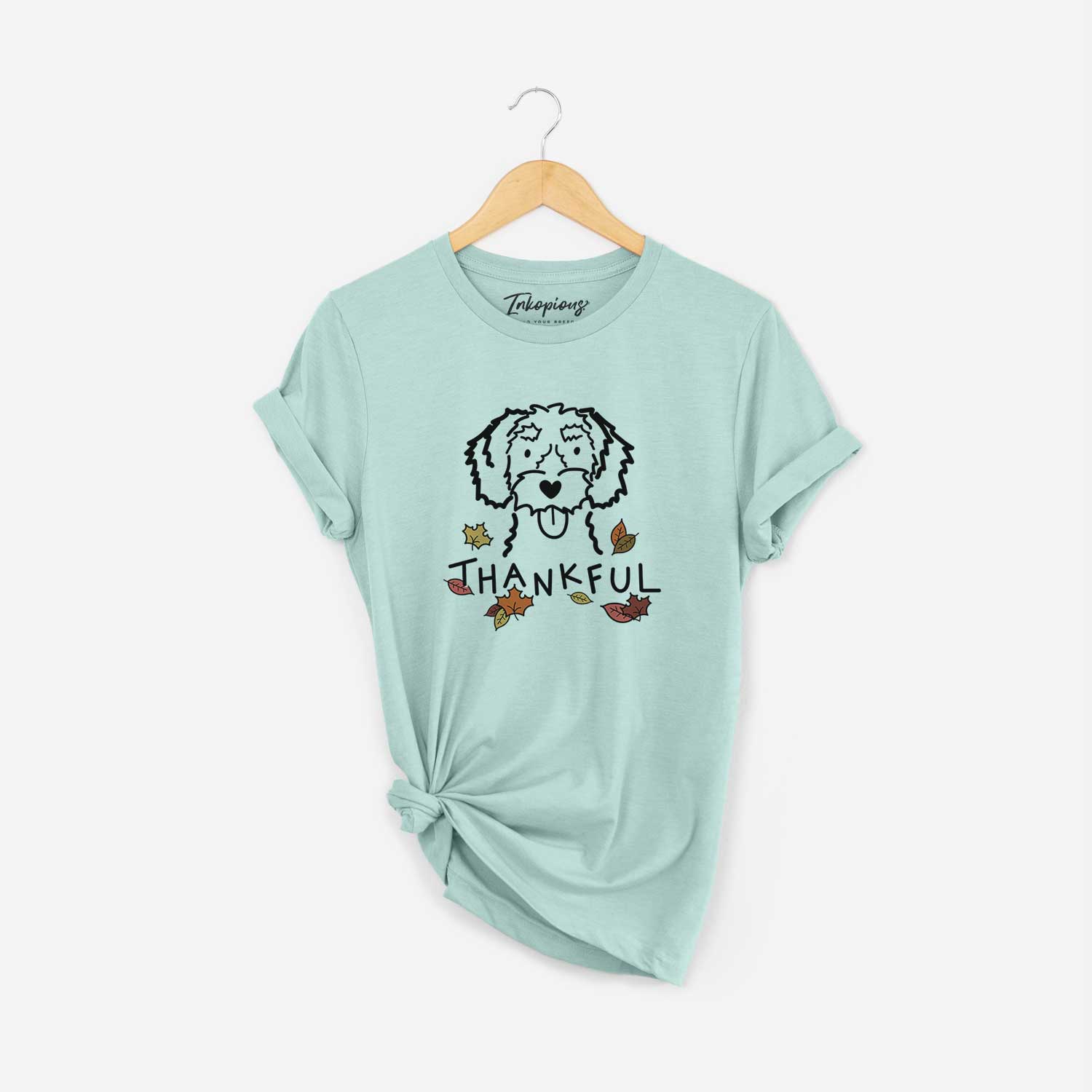 Minimalist line drawing of a White Schnoodle with 'Thankful' lettering on a Heather Sage Unisex crewneck