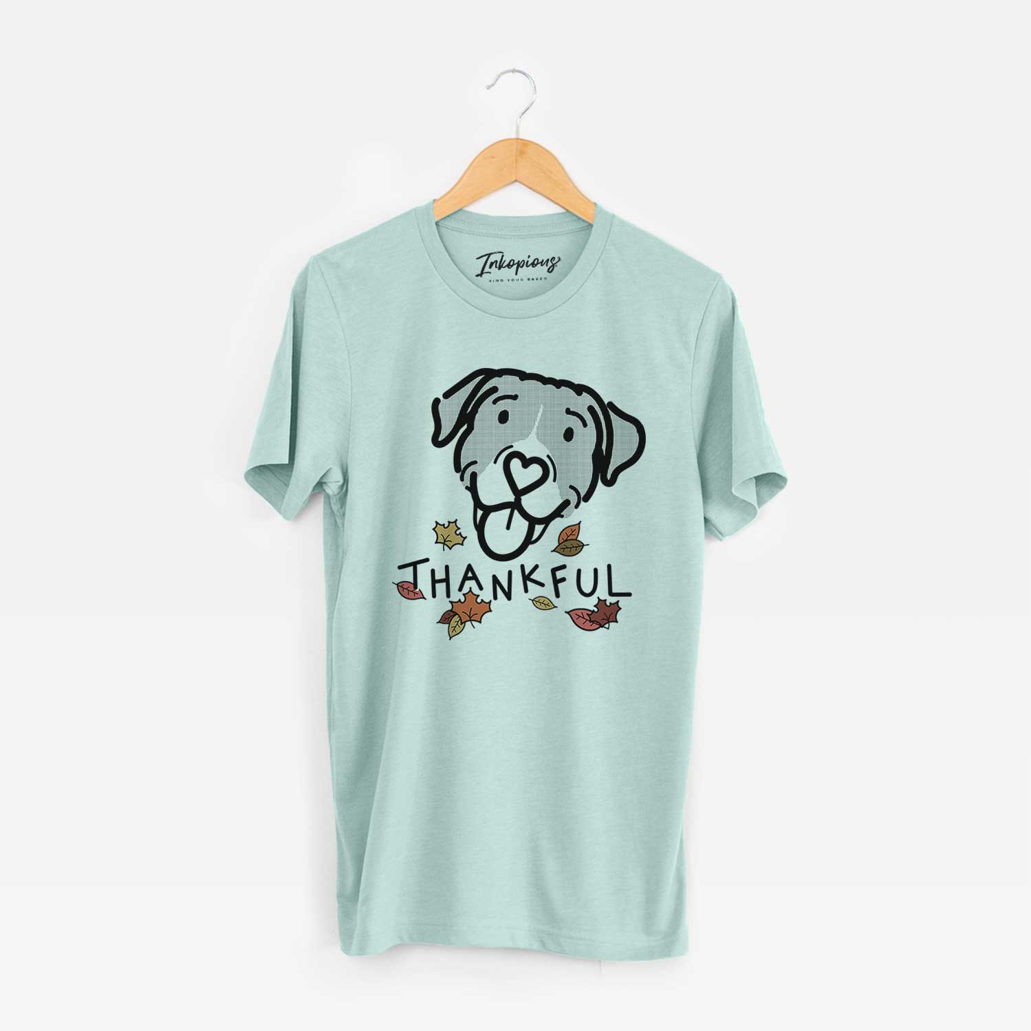 Minimalist line drawing of Shadow the Pitbull Mix with 'Thankful' lettering on a Heather Sage Unisex crewneck