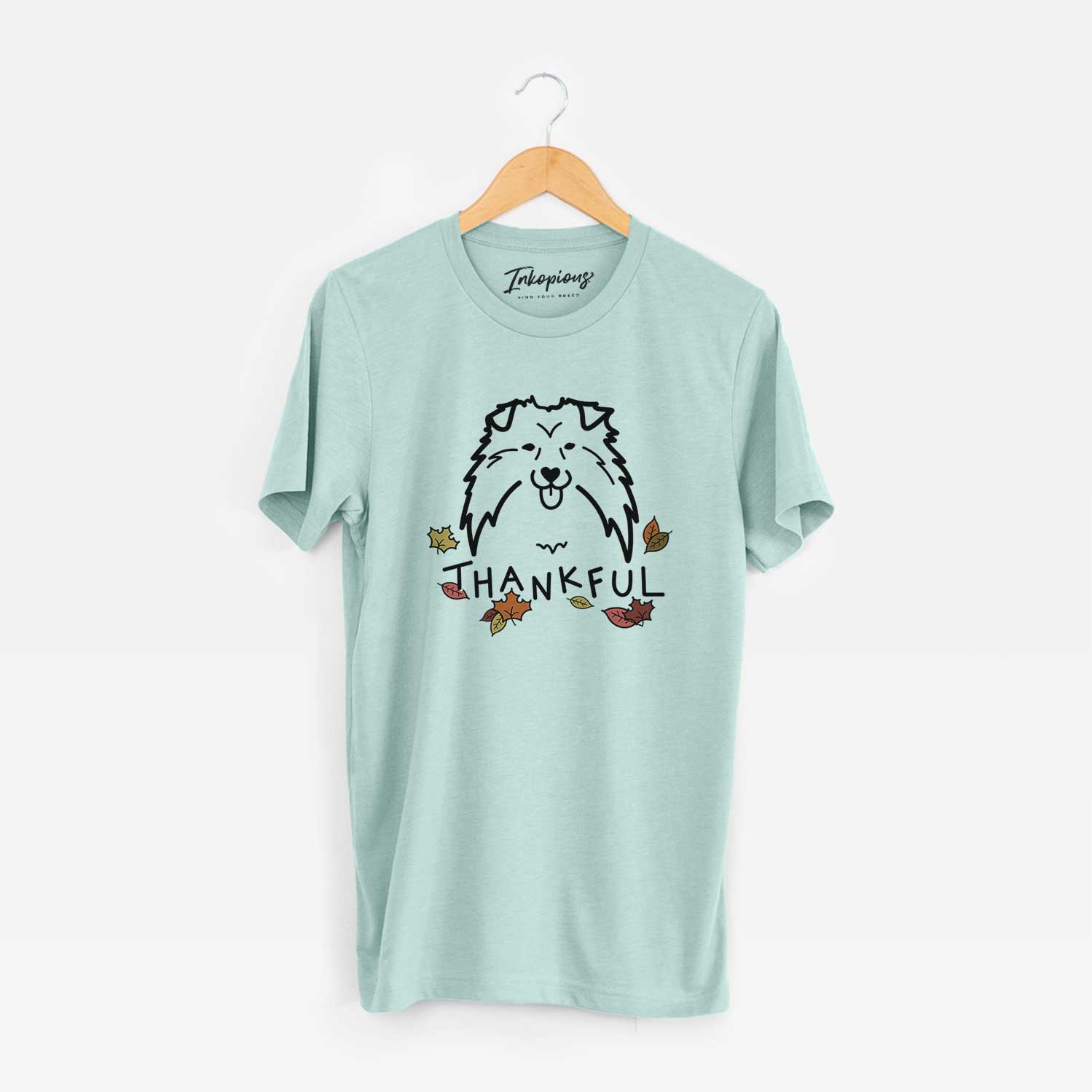 Minimalist line drawing of a Shetland Sheepdog with 'Thankful' lettering on a Heather Sage Unisex crewneck