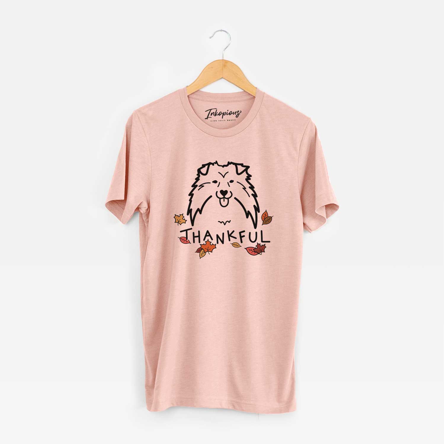 Minimalist line drawing of a Shetland Sheepdog with 'Thankful' lettering on a Peach Unisex crewneck