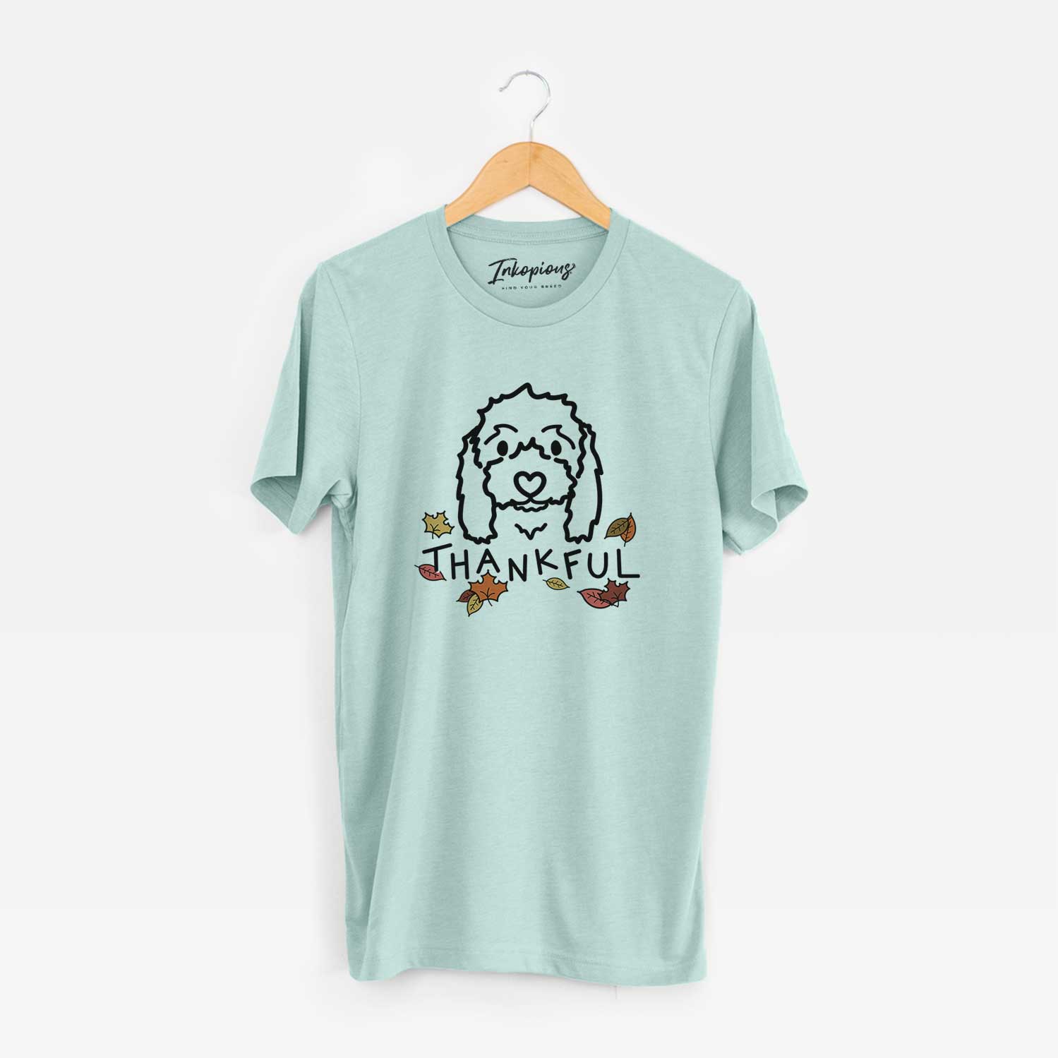 Minimalist line drawing of Sophie the Coton de Tulear with 'Thankful' lettering on a Heather Sage Unisex crewneck