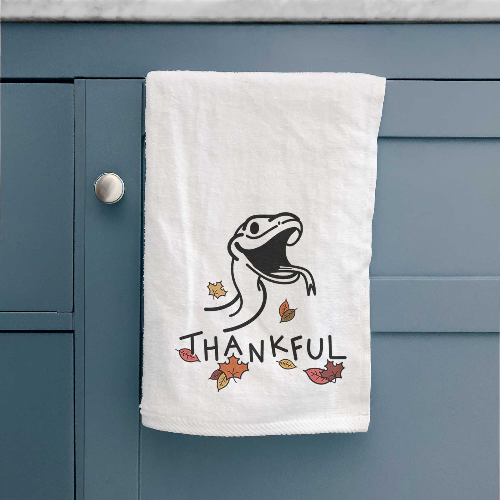 Minimalist line drawing of Spike the Snake with 'Thankful' lettering on a decorative hand towel