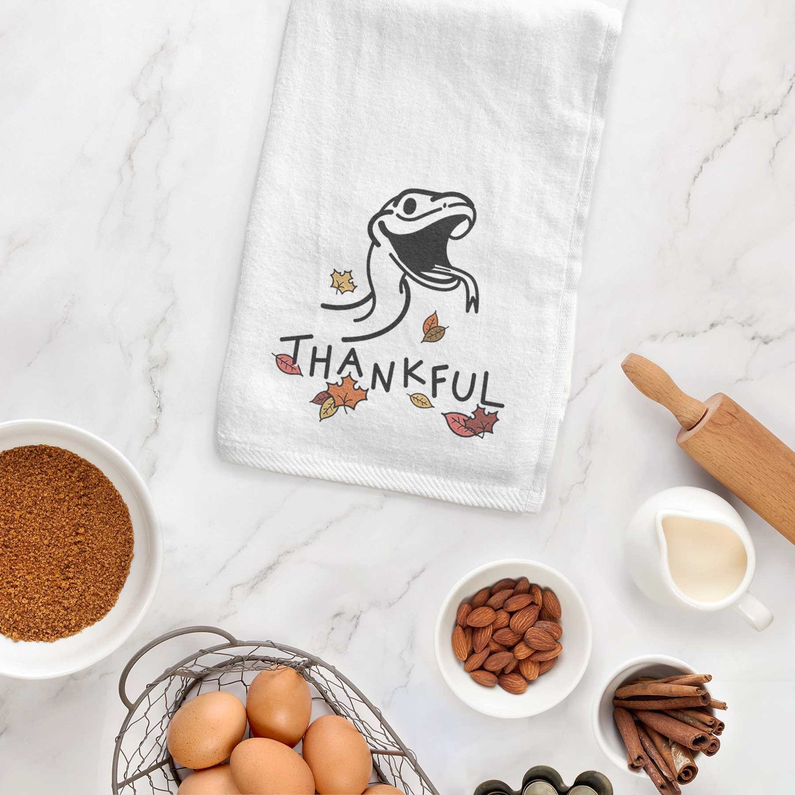 Minimalist line drawing of Spike the Snake with 'Thankful' lettering on a decorative hand towel