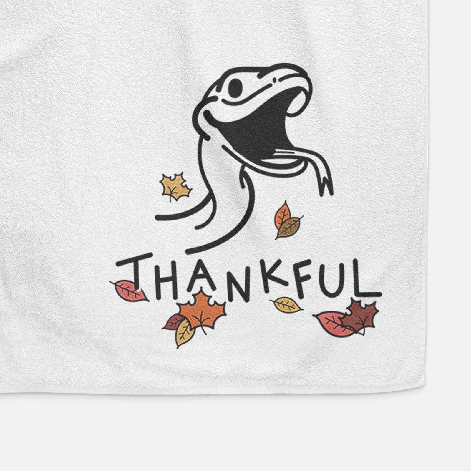 Minimalist line drawing of Spike the Snake with 'Thankful' lettering on a decorative hand towel