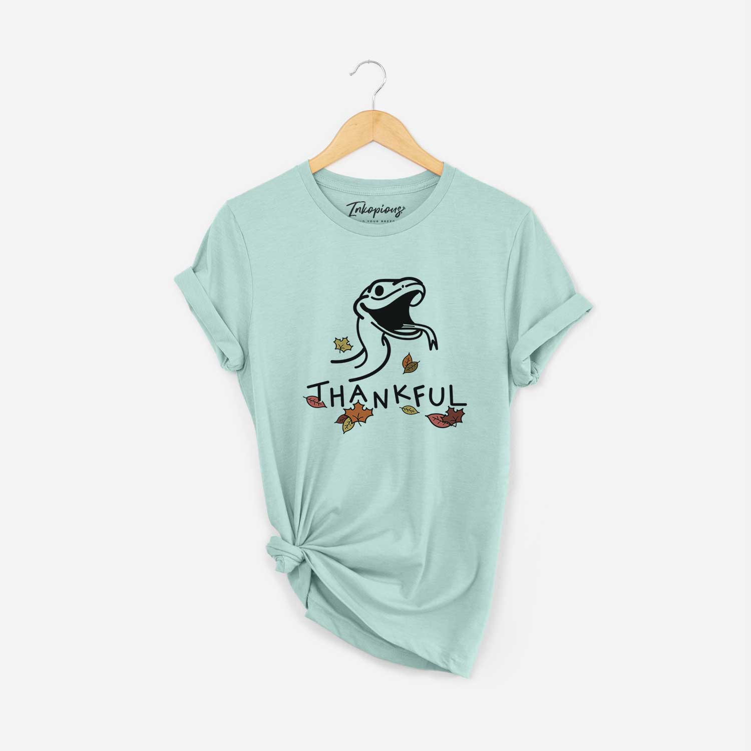 Minimalist line drawing of Spike the Snake with 'Thankful' lettering on a Heather Sage Unisex crewneck