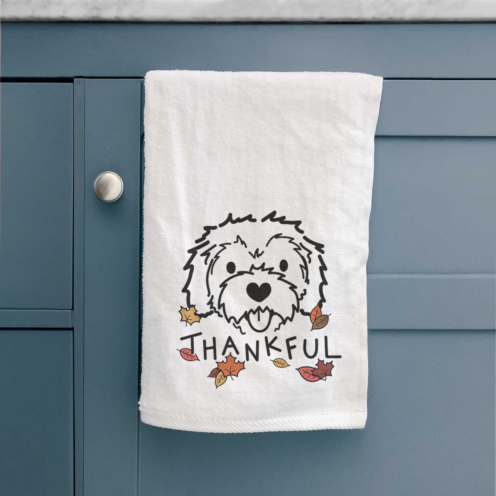 Minimalist line drawing of Sprinkles the Cockapoo with 'Thankful' lettering on a decorative hand towel