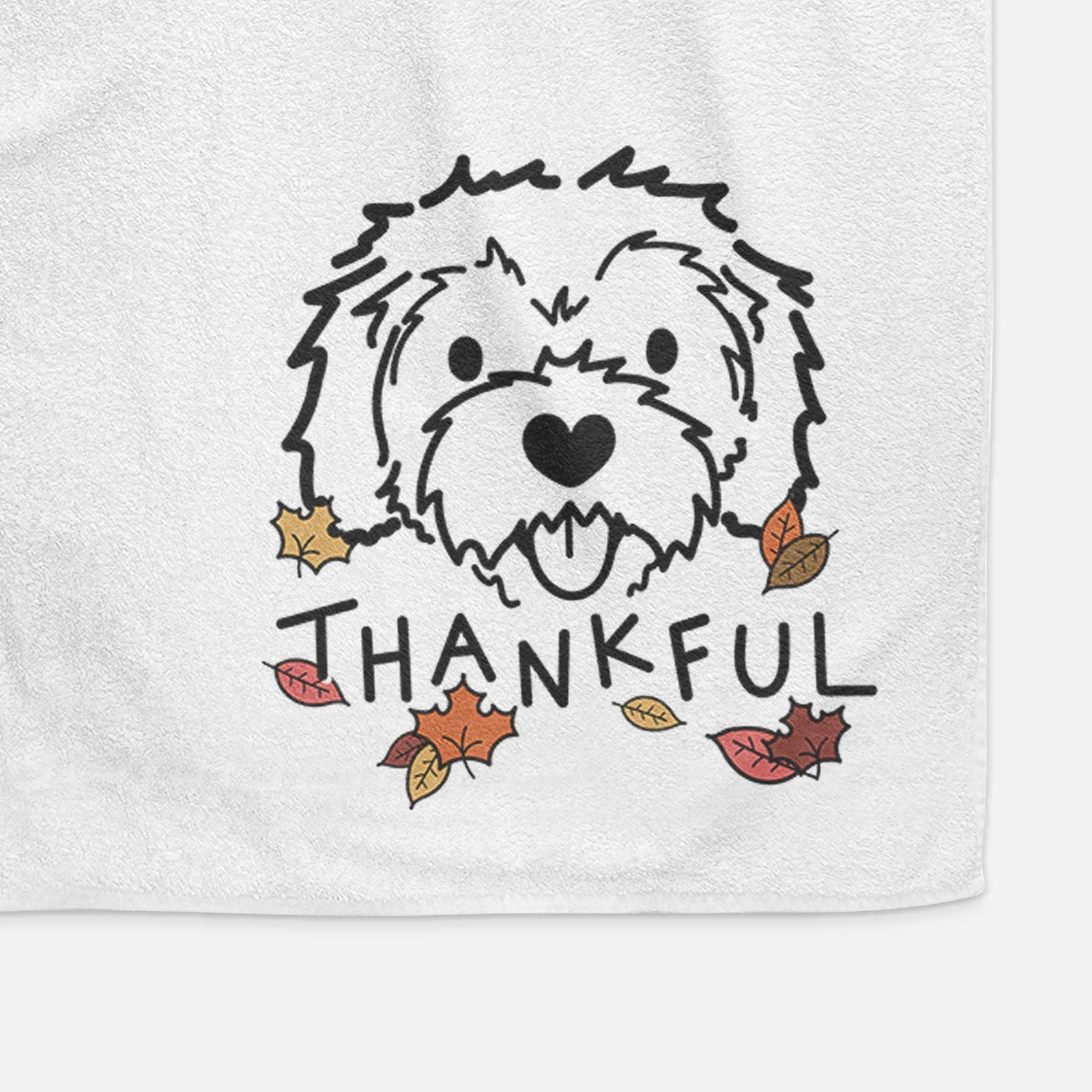 Minimalist line drawing of Sprinkles the Cockapoo with 'Thankful' lettering on a decorative hand towel