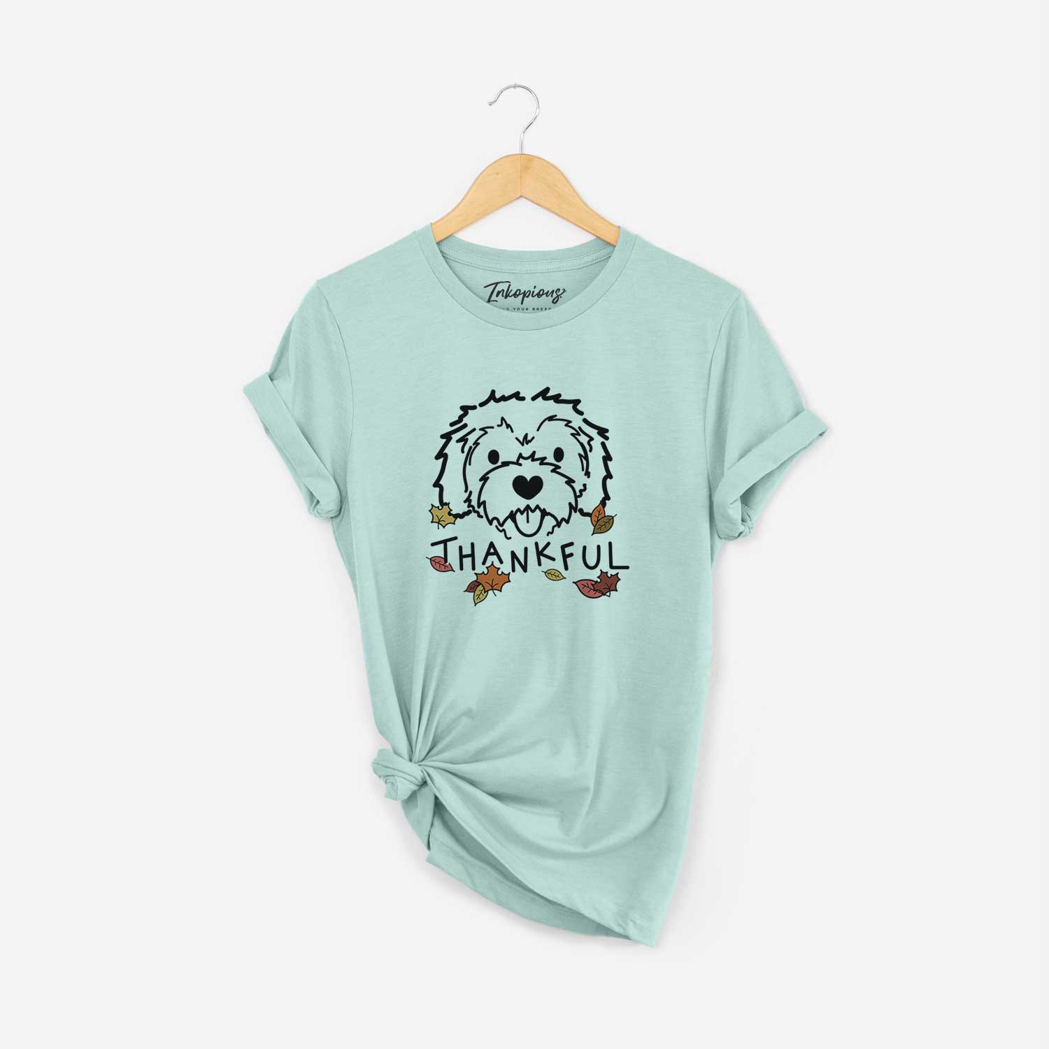 Minimalist line drawing of Sprinkles the Cockapoo with 'Thankful' lettering on a Heather Sage Unisex crewneck