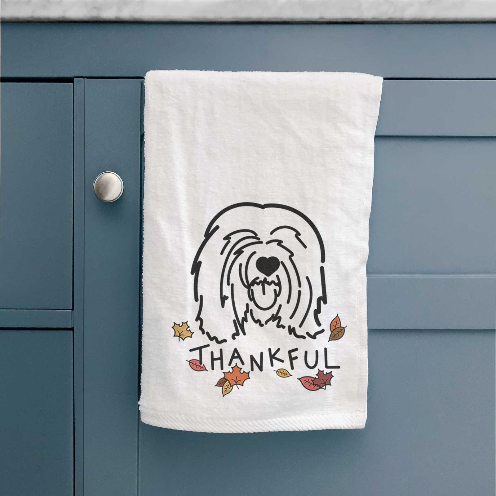 Minimalist line drawing of Stan the Tibetan Mastiff with 'Thankful' lettering on a decorative hand towel