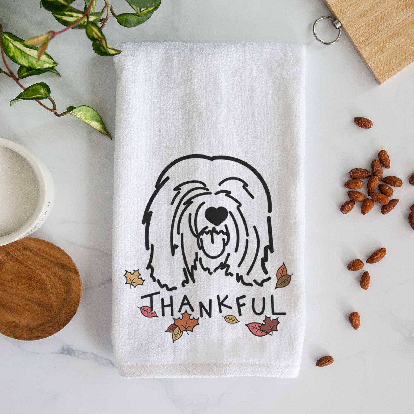 Minimalist line drawing of Stan the Tibetan Mastiff with 'Thankful' lettering on a decorative hand towel