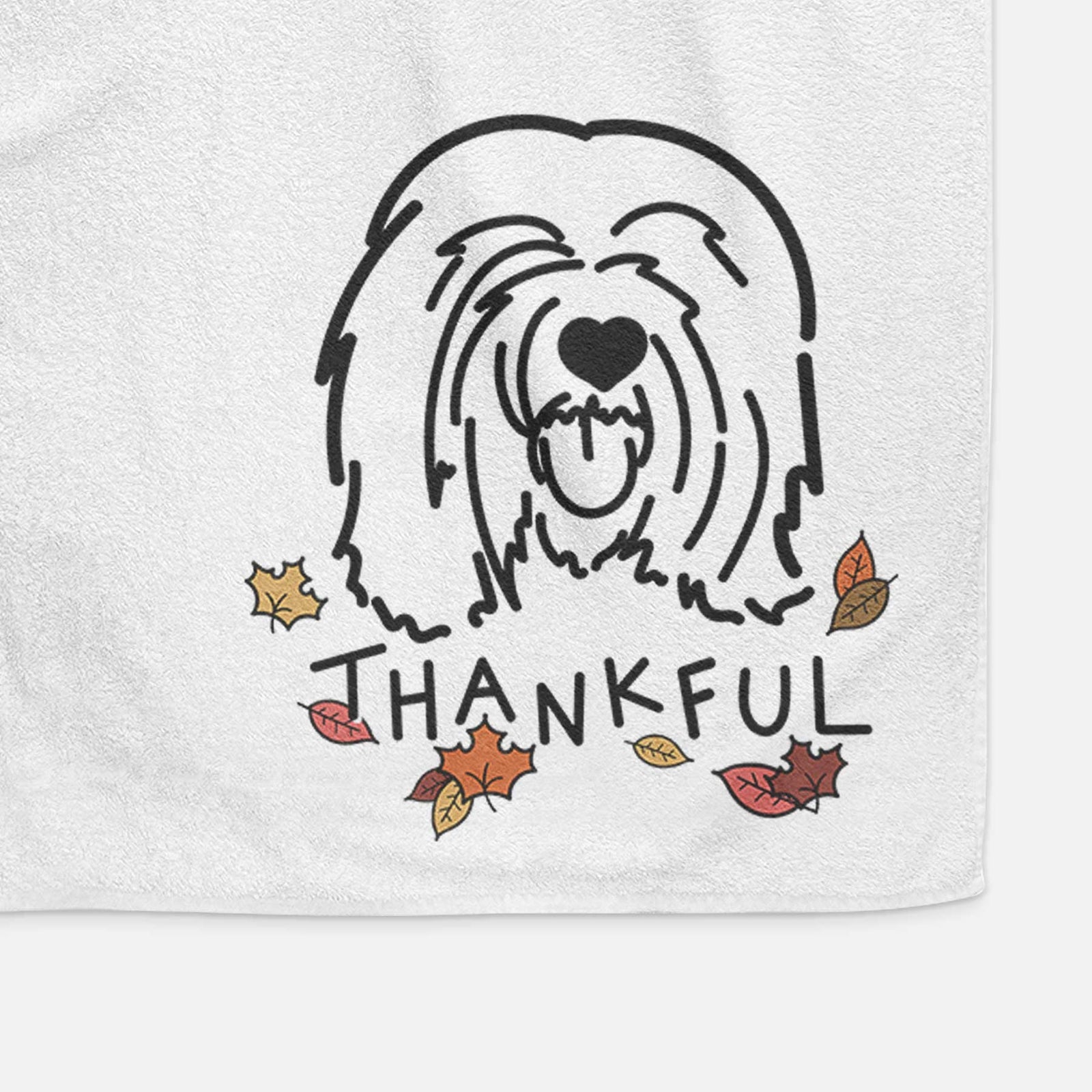 Minimalist line drawing of Stan the Tibetan Mastiff with 'Thankful' lettering on a decorative hand towel