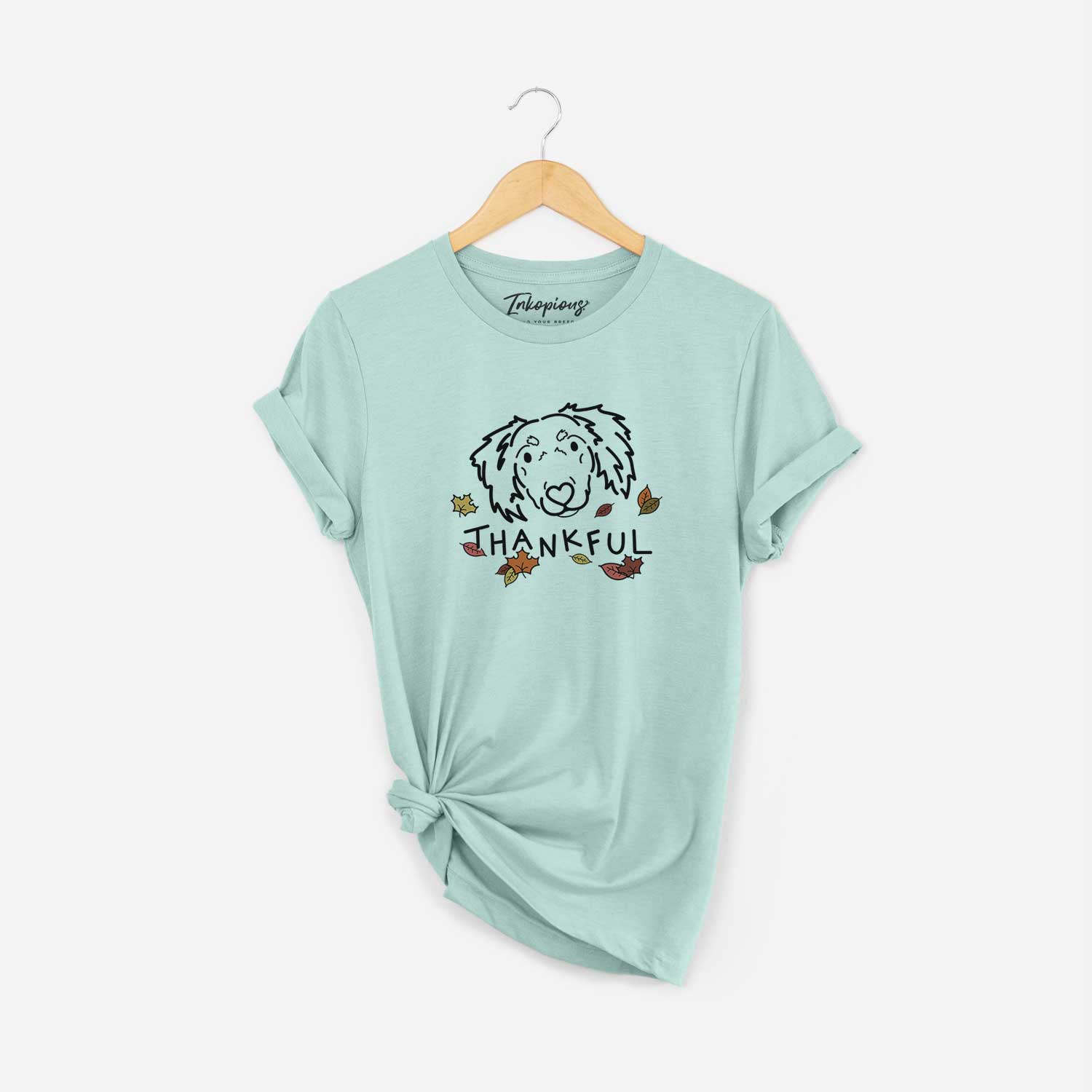 Minimalist line drawing of Tilly the Dachshund Mix with 'Thankful' lettering on a Heather Sage Unisex crewneck