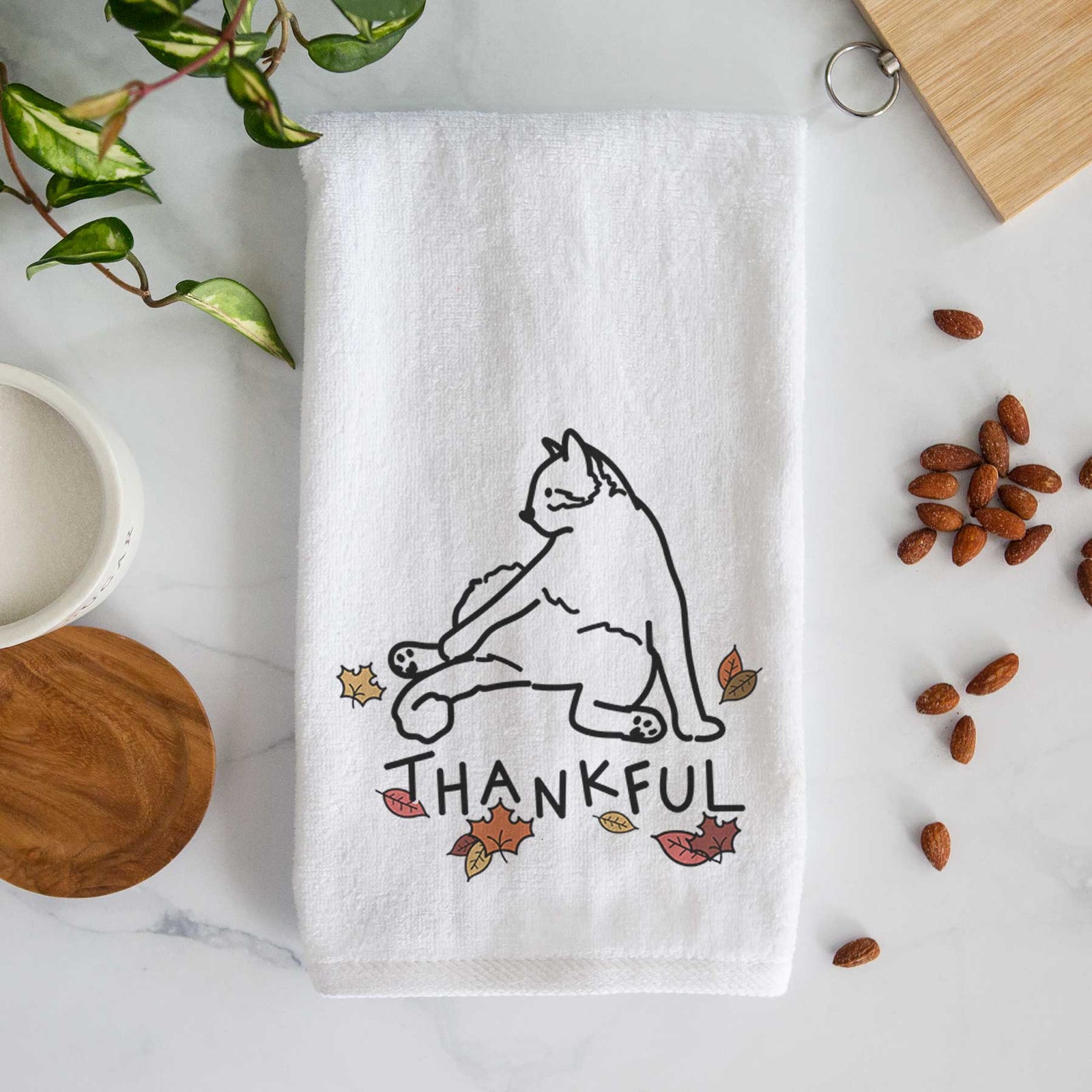 Minimalist line drawing of Tom the Cat with 'Thankful' lettering on a decorative hand towel