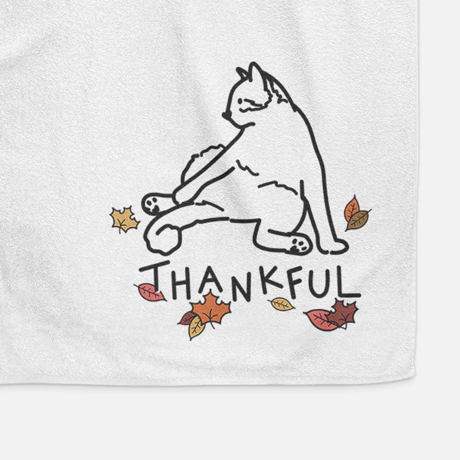 Minimalist line drawing of Tom the Cat with 'Thankful' lettering on a decorative hand towel