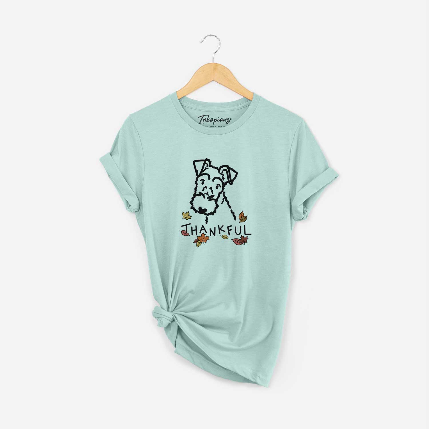 Minimalist line drawing of a Wire Fox Terrier with 'Thankful' lettering on a Heather Sage Unisex crewneck
