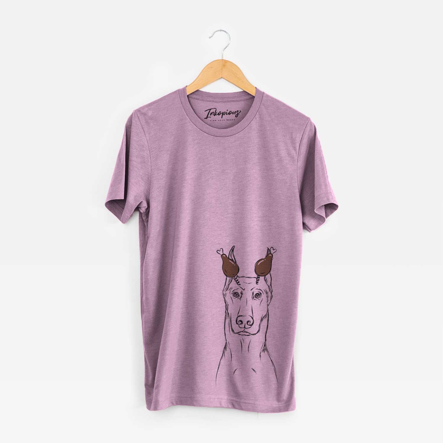 Hand-drawn sketch of Ace the Doberman Pinscher with a Thanksgiving turkey headpiece on an Orchid Unisex crewneck
