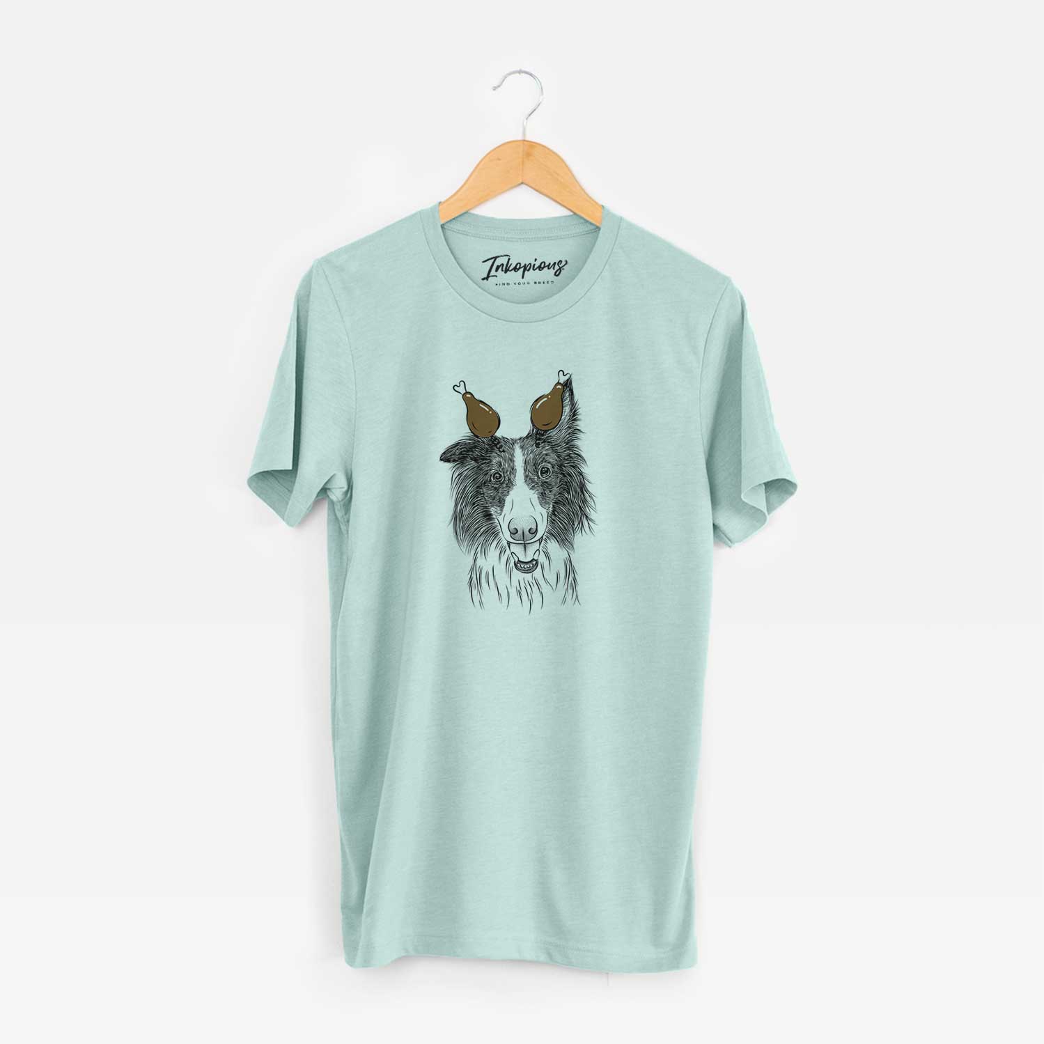Hand-drawn sketch of Archie the Silken Windhound with a Thanksgiving turkey headpiece on a Heather Sage Unisex crewneck