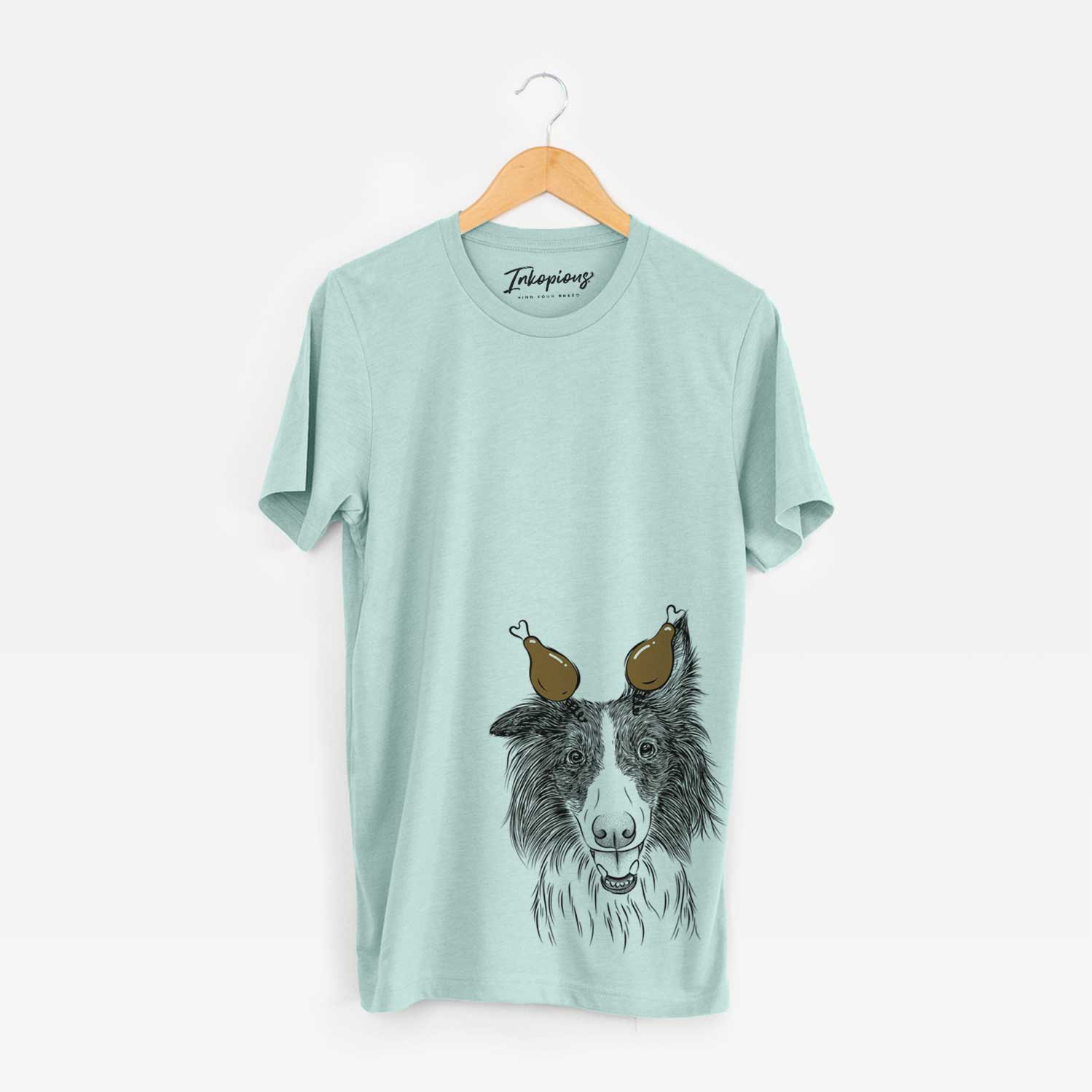 Hand-drawn sketch of Archie the Silken Windhound with a Thanksgiving turkey headpiece on a Heather Sage Unisex crewneck