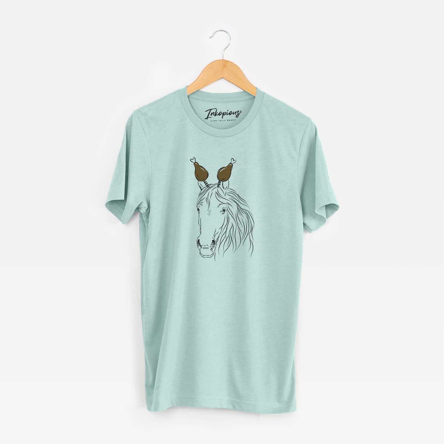 Hand-drawn sketch of Aria the Horse with a Thanksgiving turkey headpiece on a Heather Sage Unisex crewneck