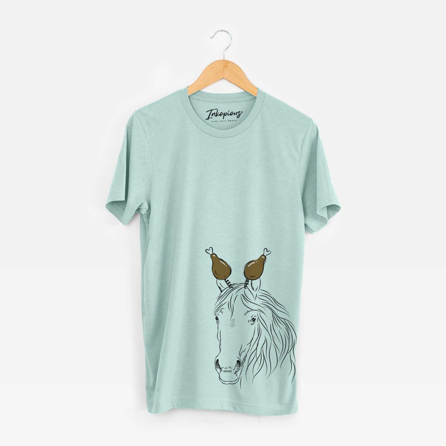 Hand-drawn sketch of Aria the Horse with a Thanksgiving turkey headpiece on a Heather Sage Unisex crewneck