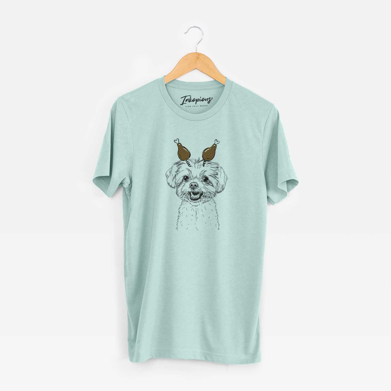 Hand-drawn sketch of Aspen the Morkie with a Thanksgiving turkey headpiece on a Heather Sage Unisex crewneck