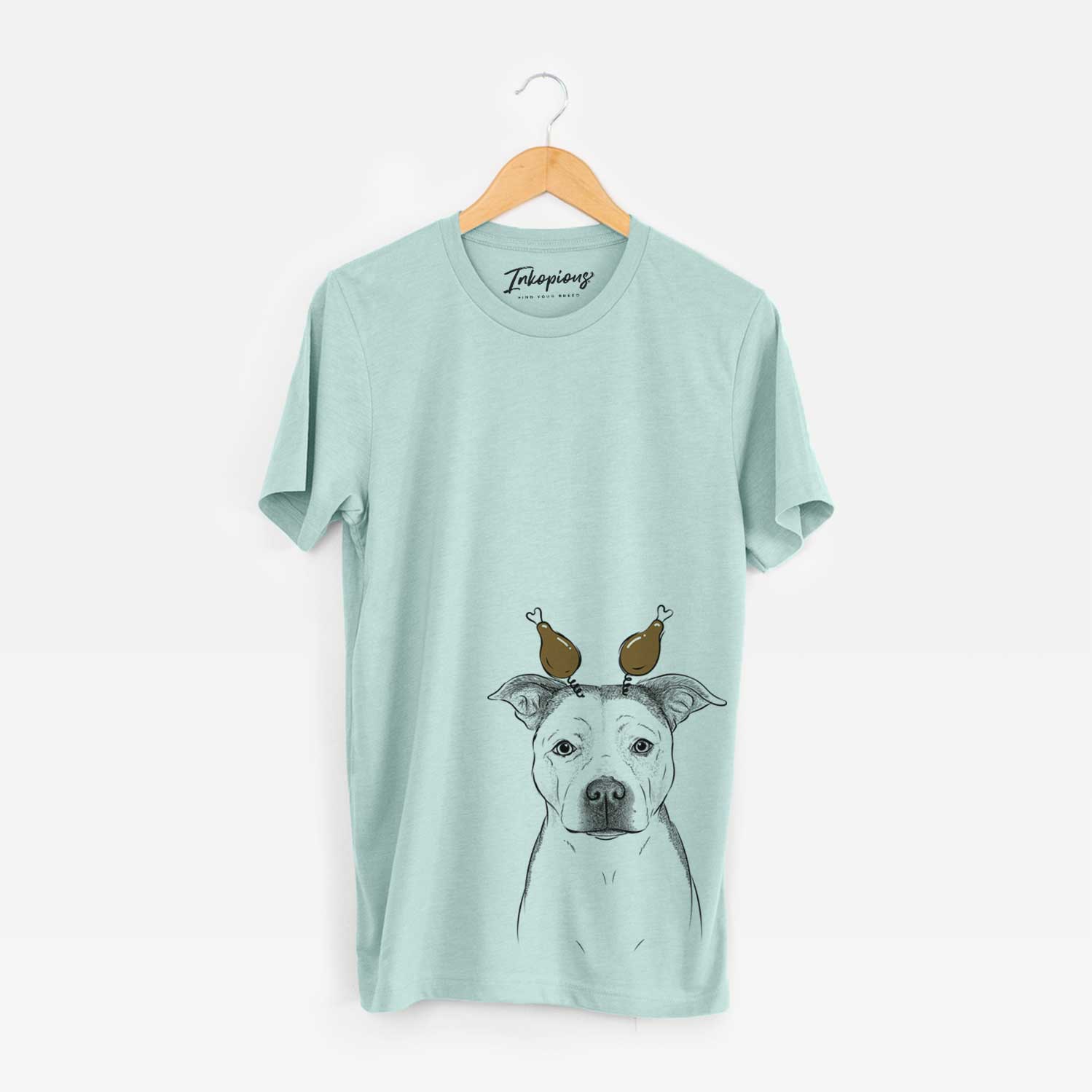 Hand-drawn sketch of Bailey the Pitbull with a Thanksgiving turkey headpiece on a Heather Sage Unisex crewneck