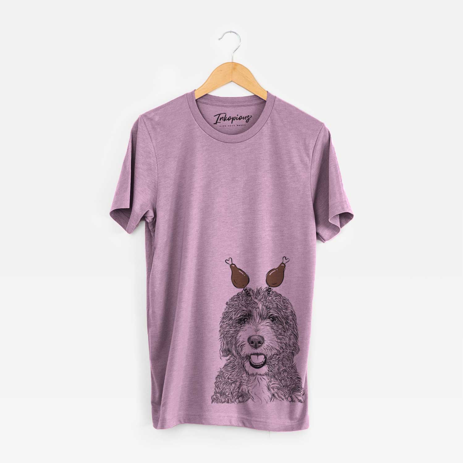 Hand-drawn sketch of Bash the Bernedoodle with a Thanksgiving turkey headpiece on an Orchid Unisex crewneck