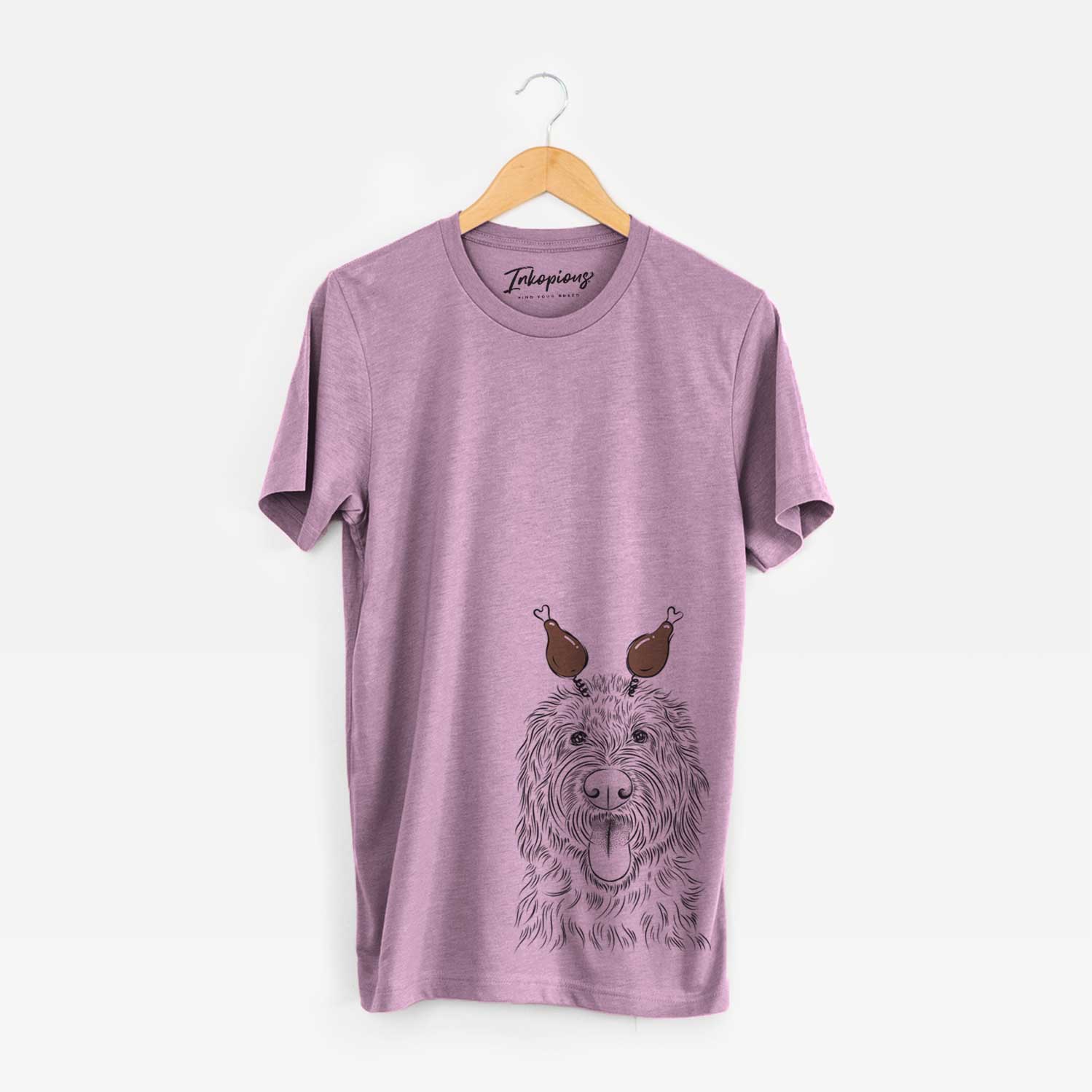 Hand-drawn sketch of Bennett the Doodle with a Thanksgiving turkey headpiece on an Orchid Unisex crewneck