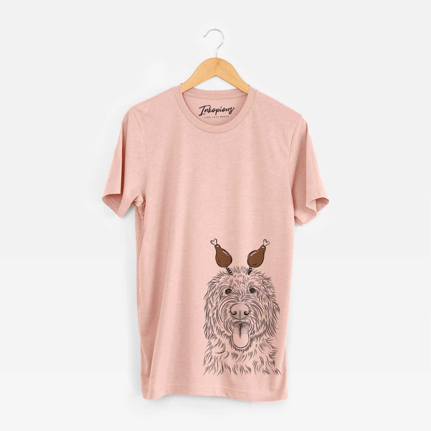 Hand-drawn sketch of Bennett the Doodle with a Thanksgiving turkey headpiece on a Peach Unisex crewneck