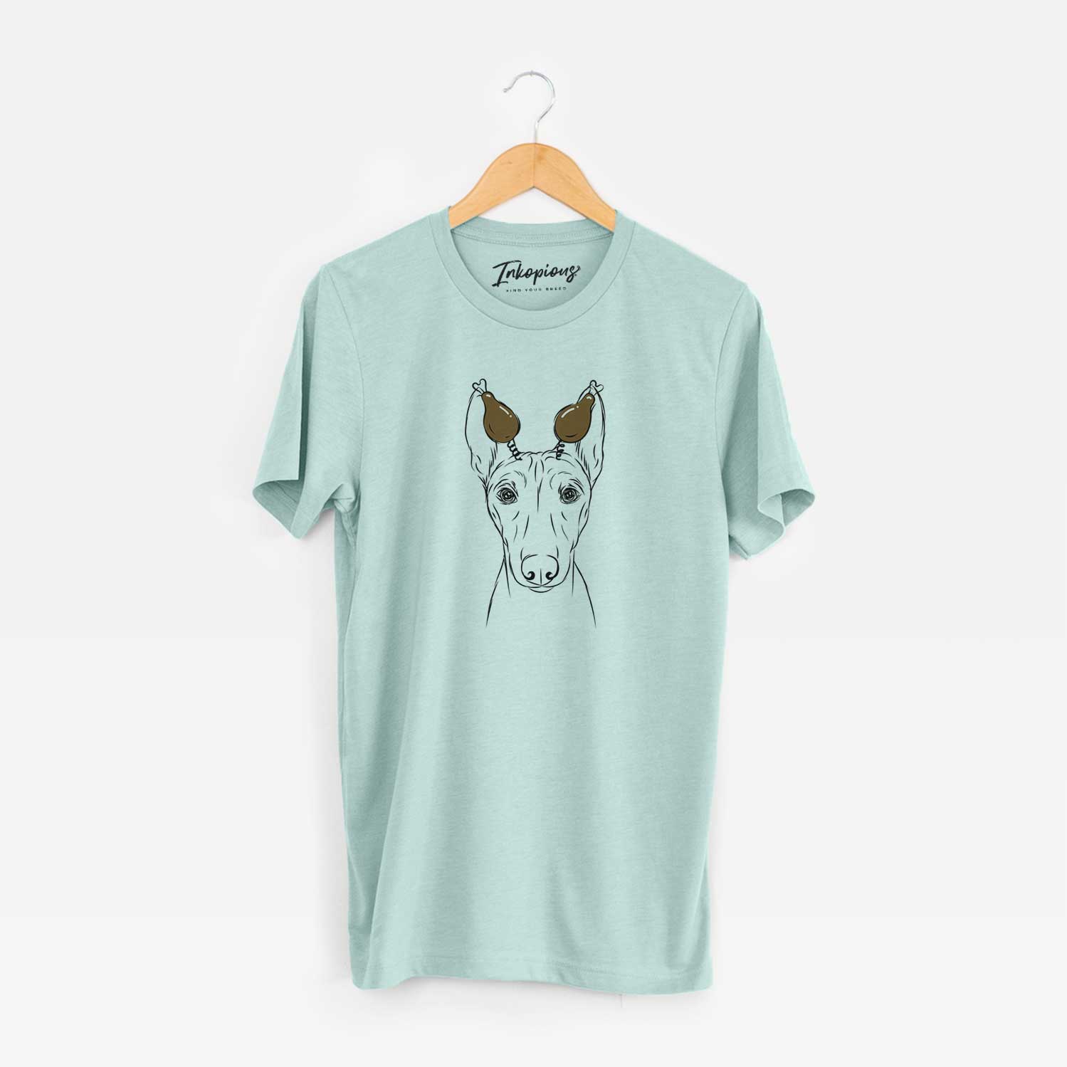 Hand-drawn sketch of Bonsai the Basenji with a Thanksgiving turkey headpiece on a Heather Sage Unisex crewneck