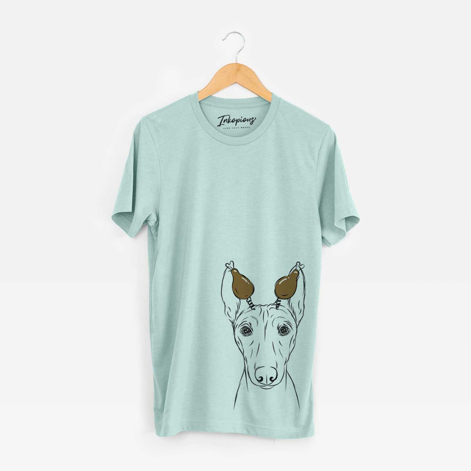 Hand-drawn sketch of Bonsai the Basenji with a Thanksgiving turkey headpiece on a Heather Sage Unisex crewneck