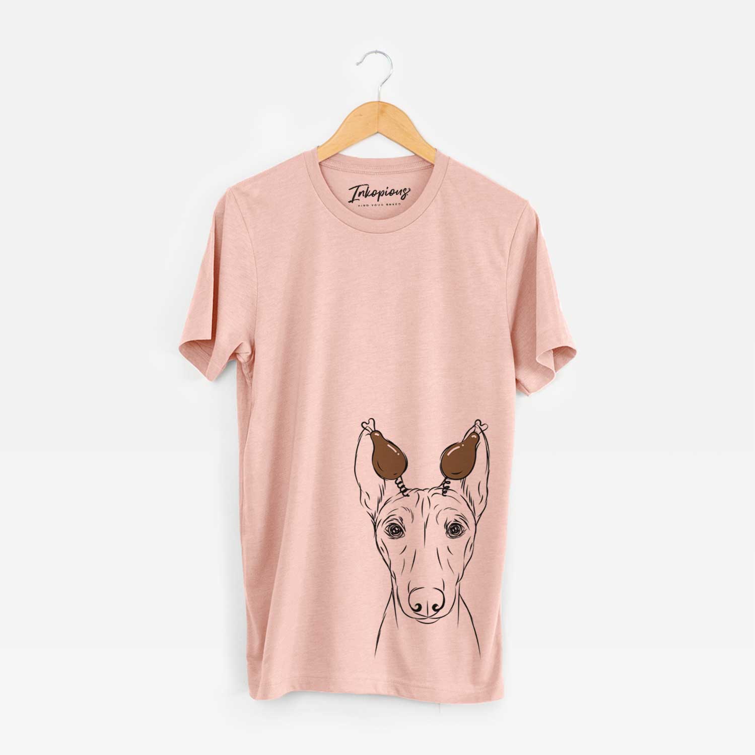 Hand-drawn sketch of Bonsai the Basenji with a Thanksgiving turkey headpiece on a Peach Unisex crewneck