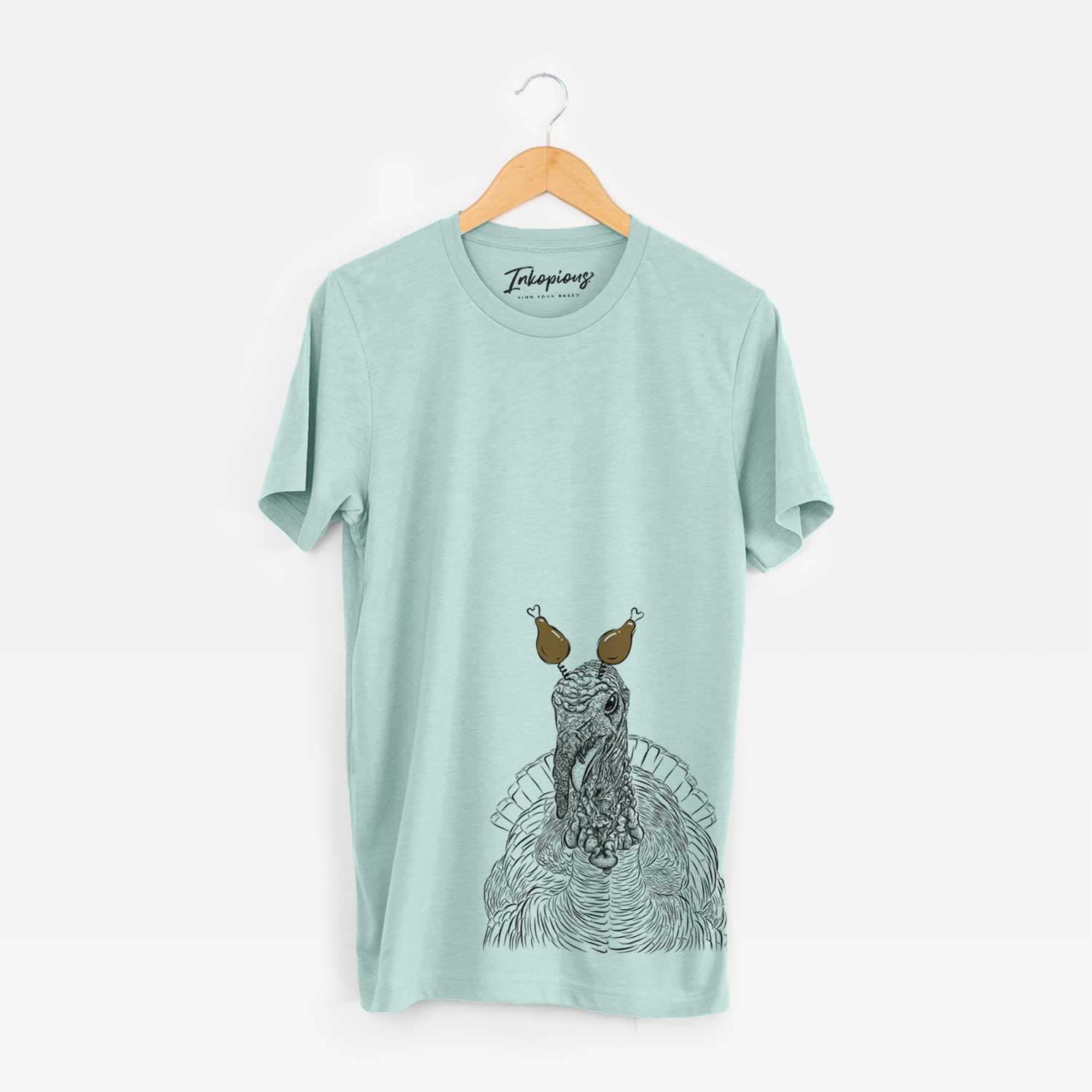 Hand-drawn sketch of Brady the Turkey with a Thanksgiving turkey headpiece on a Heather Sage Unisex crewneck