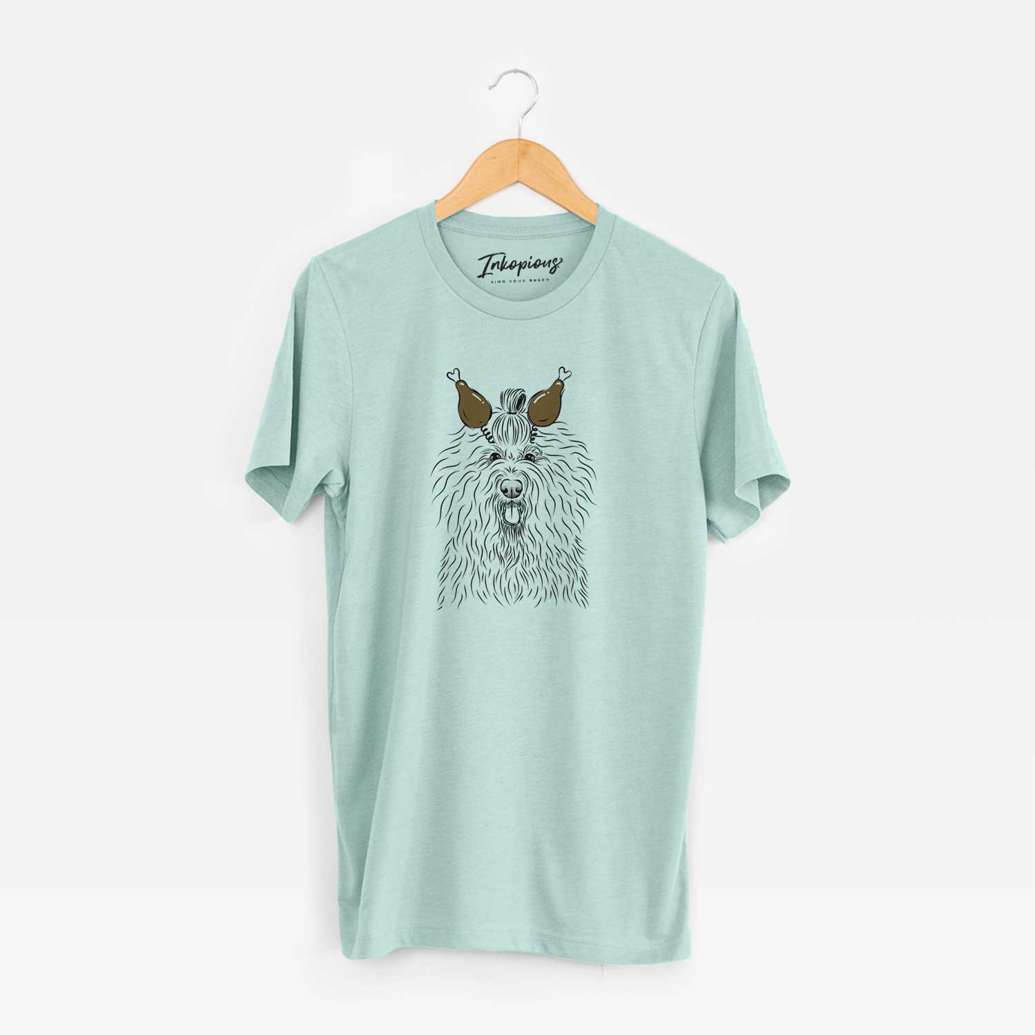 Hand-drawn sketch of Brody the Old English Sheepdog with a Thanksgiving turkey headpiece on a Heather Sage Unisex crewneck