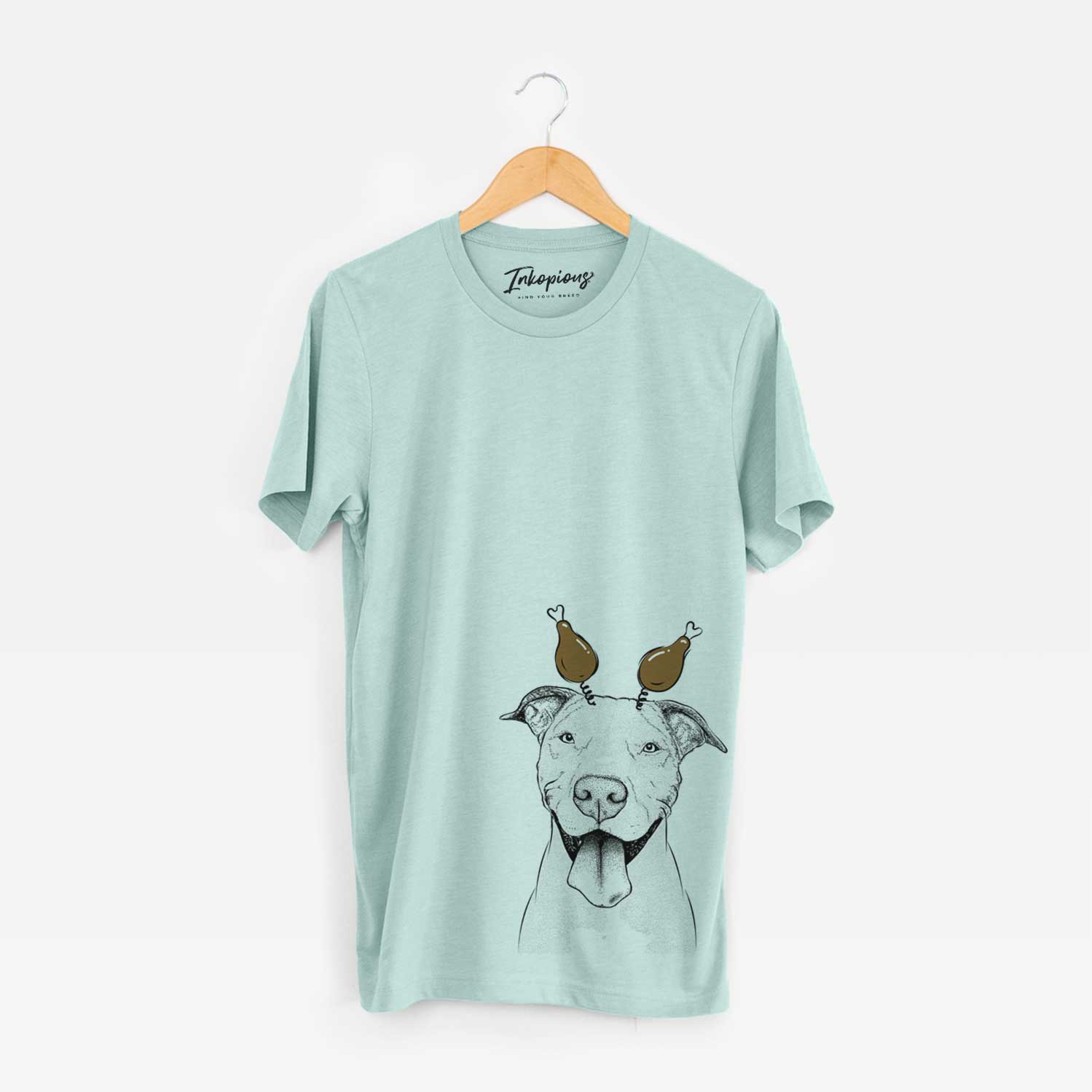 Hand-drawn sketch of Bruce the American Staffordshire Terrier with a Thanksgiving turkey headpiece on a Heather Sage Unisex crewneck