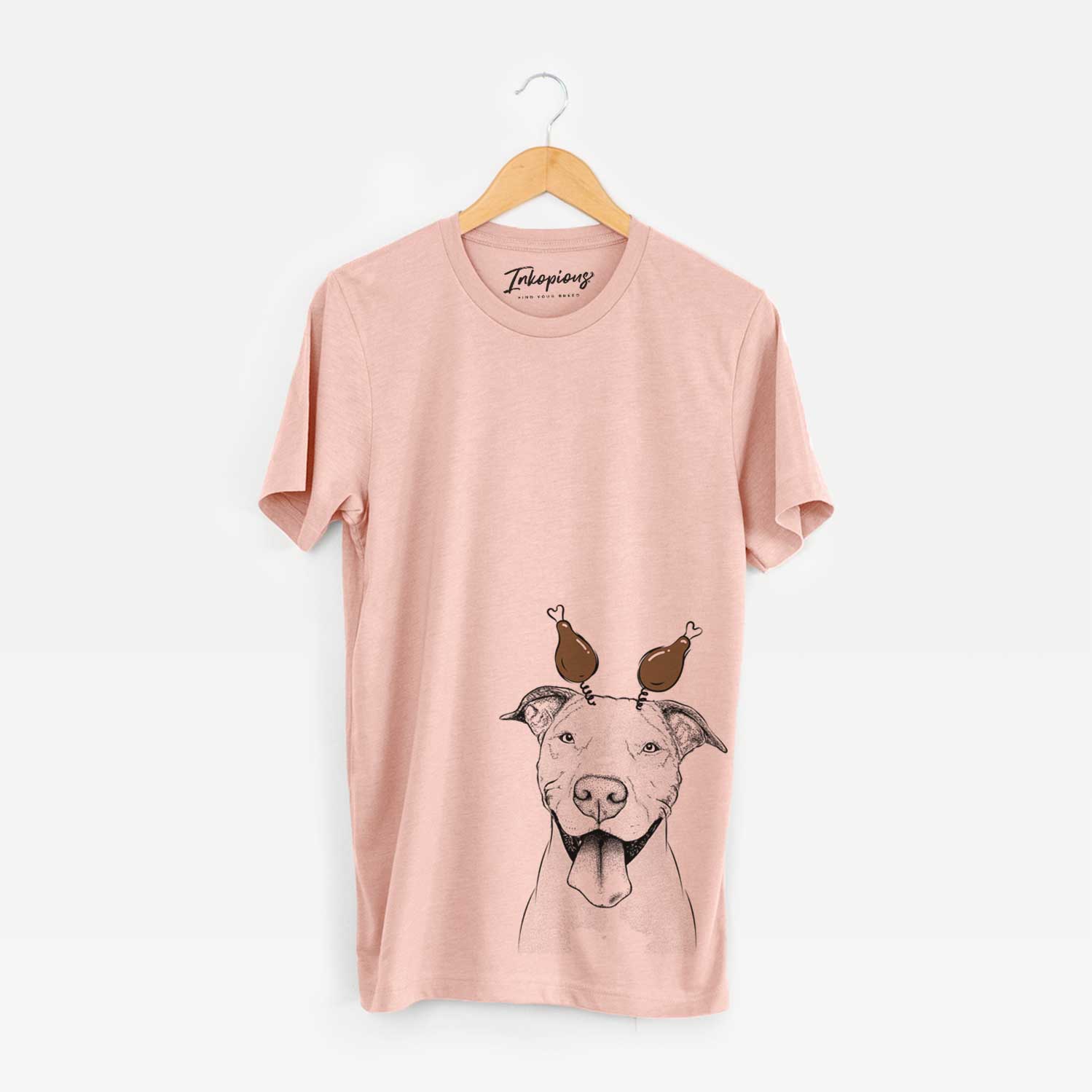 Hand-drawn sketch of Bruce the American Staffordshire Terrier with a Thanksgiving turkey headpiece on a Peach Unisex crewneck