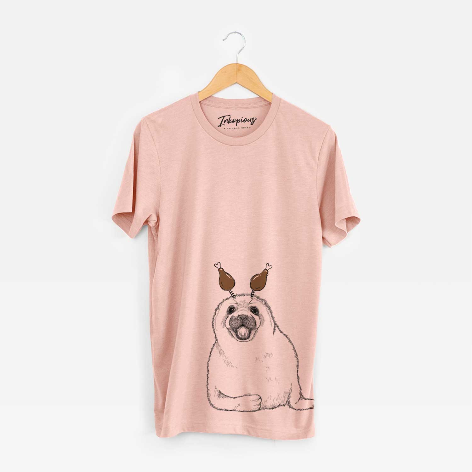 Hand-drawn sketch of Bub the Harp Seal with a Thanksgiving turkey headpiece on a Peach Unisex crewneck
