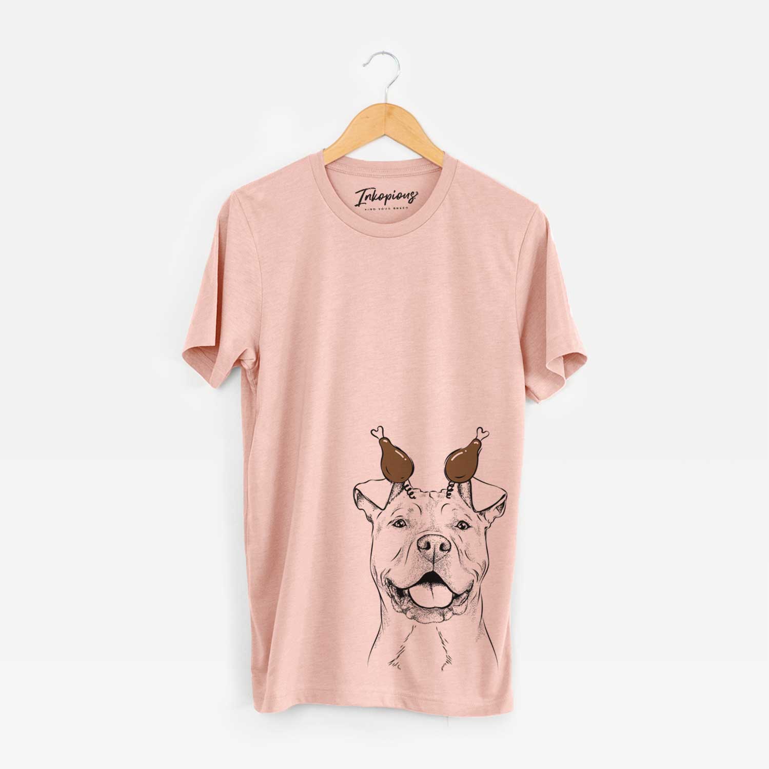 Hand-drawn sketch of Bubba Scraps the American Staffordshire Mix with a Thanksgiving turkey headpiece on a Peach Unisex crewneck
