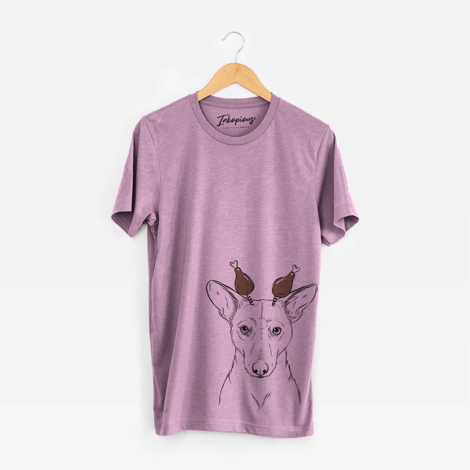 Hand-drawn sketch of Buff the Dorgi with a Thanksgiving turkey headpiece on an Orchid Unisex crewneck