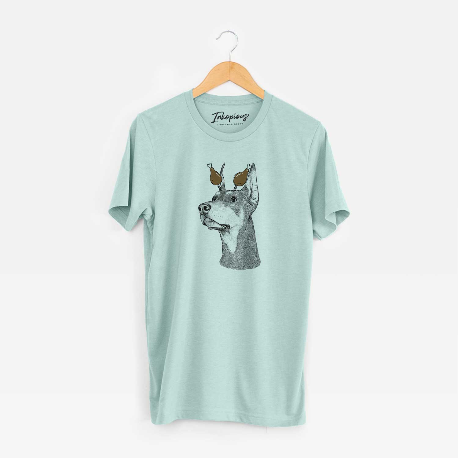 Hand-drawn sketch of Cenza the Doberman Pinscher with a Thanksgiving turkey headpiece on a Heather Sage Unisex crewneck